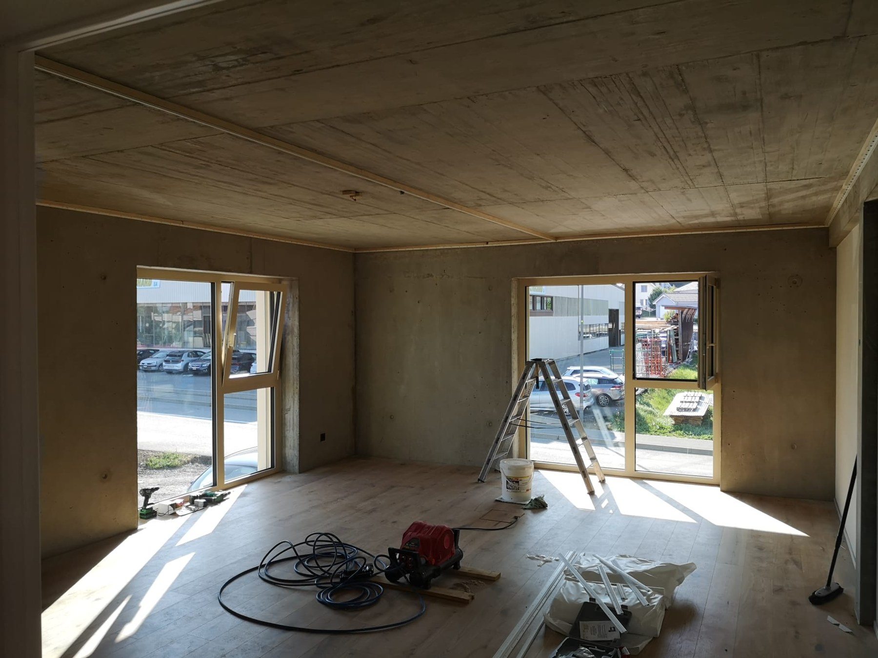 Pièce en chantier, plafond brut et outils au sol